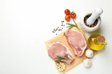 Composition with raw meat and ingredients on white background, top view