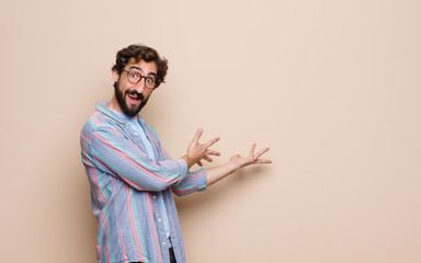 Wall Mural - young bearded man against flat wall