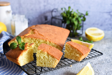 Canvas Print - Lemon cake with zest on a concrete background. View from above.