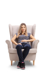 Poster - Young woman sitting calmly in an armchair