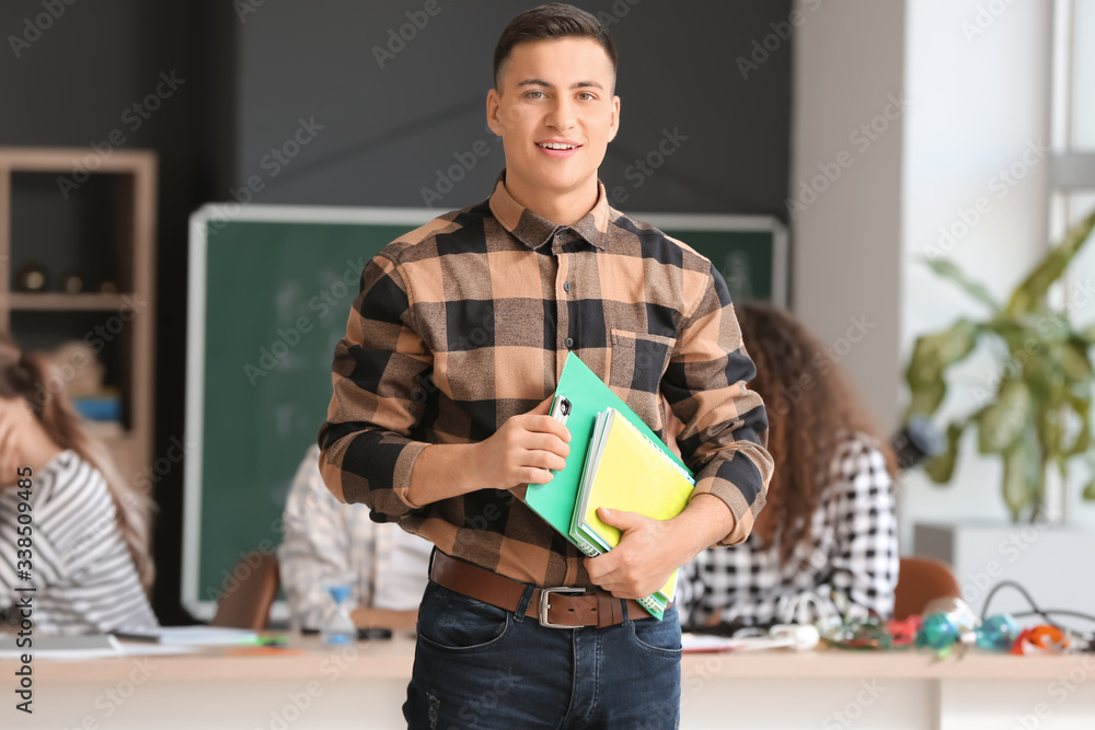 Young man at physics lesson in classroom