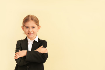 Canvas Print - Portrait of little businesswoman on color background