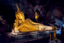 PHANG NGA, THAILAND,Wat Tham Suwan Khuha Cave. Golden Statue Of Buddha Of Nirvana In Buddhist Cave Temple In Wat Tham Suwankhuha Cave ,Monkey Cave In Phang Nga, Thailand