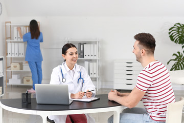 Wall Mural - Male patient visiting doctor in clinic