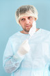 © alenaphoto - Portrait shot of the Caucasian tired man doctor in medical hat taking off mask from his mouth and not to the camera.