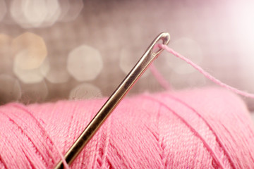 Wall Mural - A macro image of a needle s eye threaded, pink thread