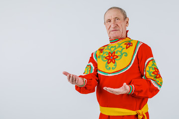 An elderly man in Slavic clothing on a white background