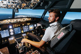 Fototapeta  - First officer is controlling autopilot and parameters for safety flight. Cockpit of Boeing aircraft. Content is good any airline.