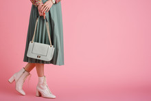 Women`s Fashion Concept: Model Wearing Trendy White Lace Up Ankle Boots, Pleated Skirt, Holding Stylish Small Green Mint Color Faux Leather Bag, Posing On Pink Background. Copy, Empty Space For Text
