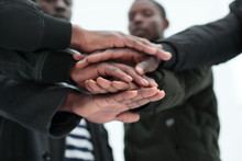 Close Up. A Group Of Friends Putting Their Hands Togethe