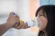 © Teran - Mexican little girl with respiratory failure due to coronavirus pandemic using inhaler