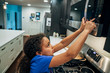 © Inti St. Clair - Girl using microwave to cook food in home kitchen