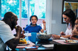 © Inti St. Clair - Family eating dinner together at dining room table