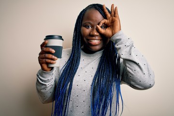 Sticker - Young african american plus size woman with braids drinking cup of takeaway coffee with happy face smiling doing ok sign with hand on eye looking through fingers