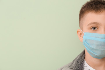 Sticker - Little boy wearing protective mask on color background. Concept of epidemic