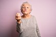 © Krakenimages.com - Senior beautiful woman wearing casual t-shirt standing over isolated pink background Doing Italian gesture with hand and fingers confident expression