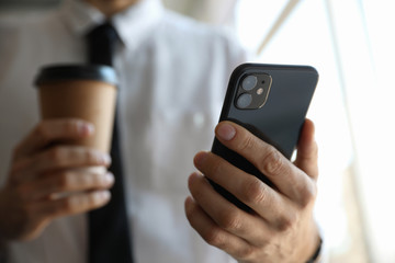 MYKOLAIV, UKRAINE - MARCH 16, 2020: Man holding iPhone 11 Black indoors, closeup