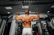 © Andrii - An athlete performs pull-UPS in the gym. Fitness, bodybuilding