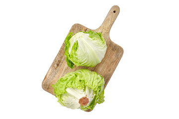 Iceberg lettuce on wooden cutting board, leafy green vegetable isolated on white background