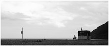 Person Sitting On Chair By Sea Against Sky At Bray