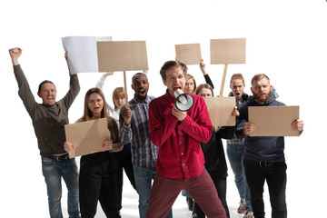 Emotional multicultural group of people screaming while holding blank placards on white background. Women and men shouting, calling. Activism, active citizenship, social life, protesting, human rights