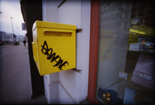 Graffiti On Yellow Post Drop Box