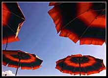 Striped Beach Umbrellas Against Blue Sky