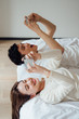 © JodieWang - Young Asian couple at home using a smartphone