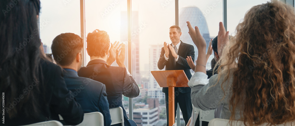 business seminar background of caucasian seminar speaker in front of conference room with seminar audiences having hands clapping together - obrazy, fototapety, plakaty 