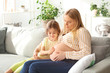 © Pixel-Shot - Beautiful pregnant woman with her little daughter at home