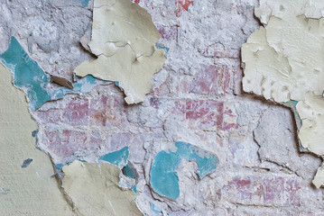 Old brick wall with peeling plaster