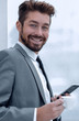 © ASDF - Stylish man in suit is reading information on phone