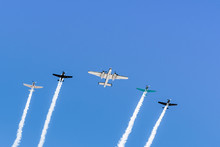 Historical Airplanes Flying In Formation, Leaving Behind A White Smoke Trail; California