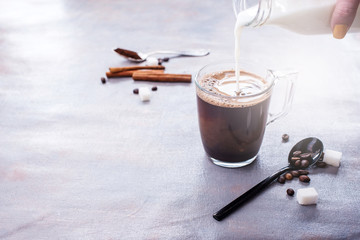 Wall Mural - Delicious and fragrant coffee with a glass cup of milk, sticks of fragrant cinnamon, coffee beans, sugar cubes