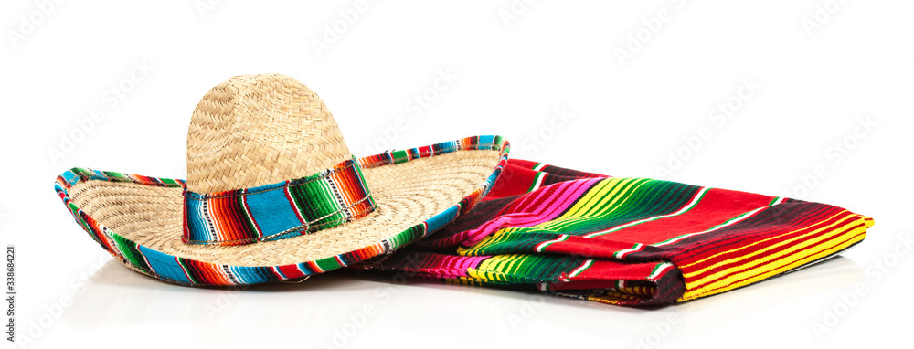 A woven Mexican sombrero or hat with a colorful serape blanket - obrazy, fototapety, plakaty 