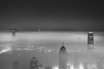 Wall Mural - Misty night view of Victoria harbor in Hong Kong city