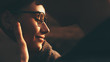 © Strelciuc - Close up portrait of a caucasian man kissing his wife with eyeglasses while sitting in a field