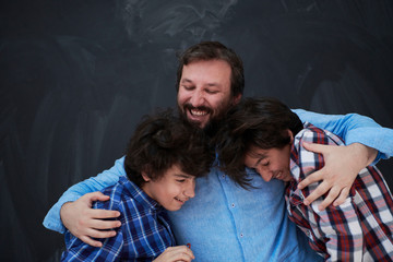 Wall Mural - happy father hugging sons