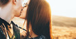 © Strelciuc - Lovely caucasian couple kissing each other in the field during a sunny day