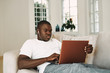© SHOTPRIME STUDIO - man of african appearance at home in front of a laptop