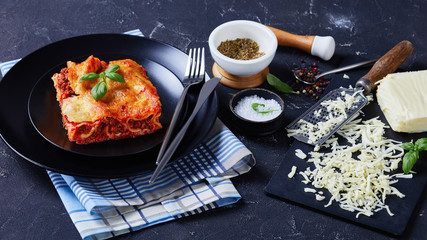 Wall Mural - A portion of pasta manicotti on a black plate