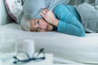 Hyperacusis Disorder.  Mature Woman Suffering From Hyperacusis, Fear of Sounds Holding Pillow Over Her Head