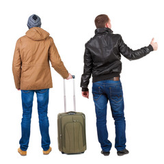 Poster - Back view of two man in winter jacket traveling with suitcas.