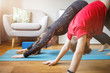 © skumer - Small boy with his mother practicing yoga at home