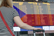 © artmim - Woman looks at the scoreboard at the airport. Select a country Czech Republic for travel or migration.