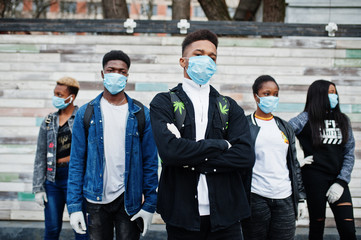 Group of african teenagers friends wearing medical masks protect from infections and diseases coronavirus virus quarantine.