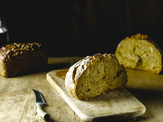 rye bread on a wooden table and on a black background, rustic style