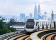 Malaysia Mass Rapid Transit (MRT) train with a background of Kuala Lumpur cityscape. People commute with MRT as transportation to work, school, travel, and shopping.