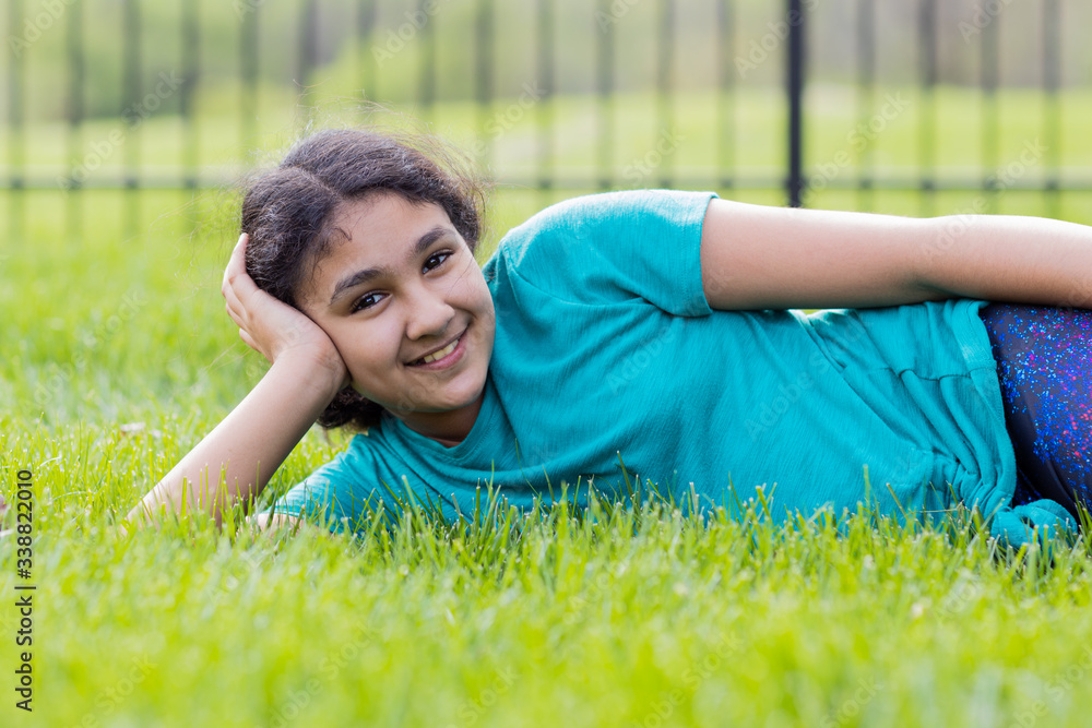 Outdoor Portrait of a Smiling Little Girl Lying on Grass in Spring ...