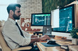 © gstockstudio - Handsome young modern man in formalwear working using computers